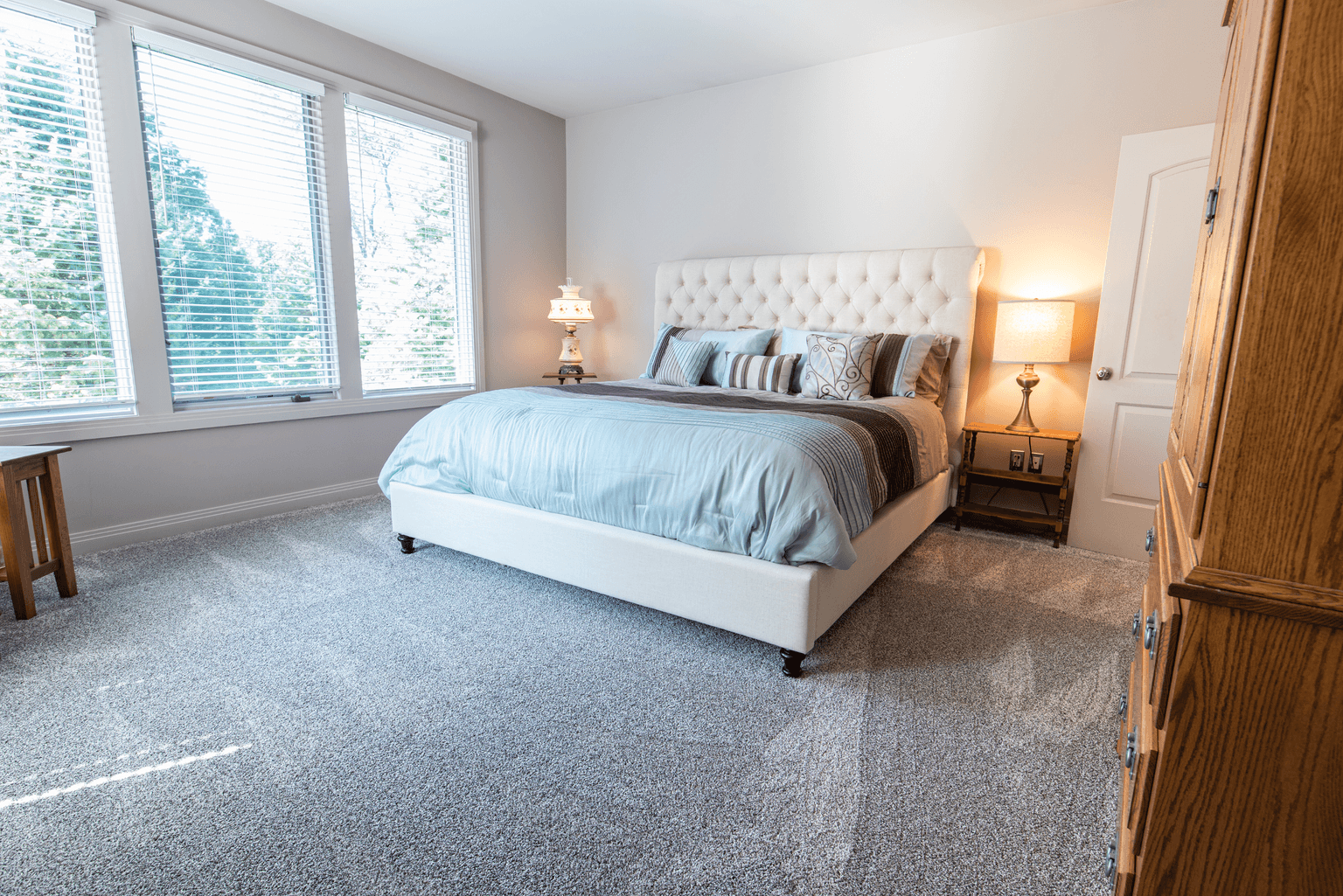 Bright bedroom with freshly cleaned gray carpet in a Chapin, SC home